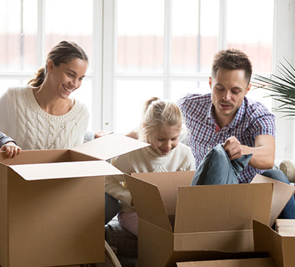 family unpacking boxes